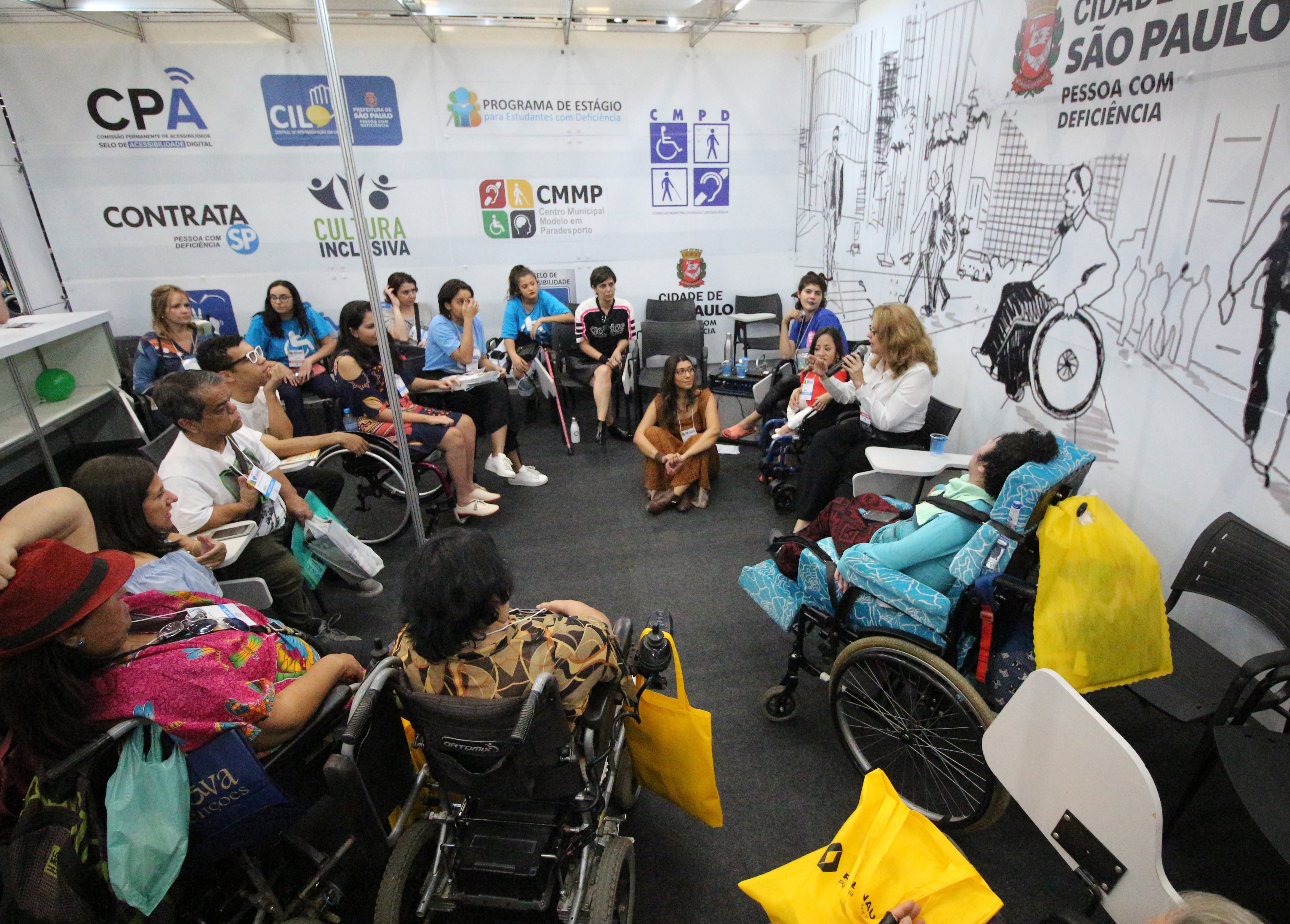Roda de conversa sobre Moda Inclusiva, na foto, pessoas sentadas formando um circulo, debatendo sobre o tema.